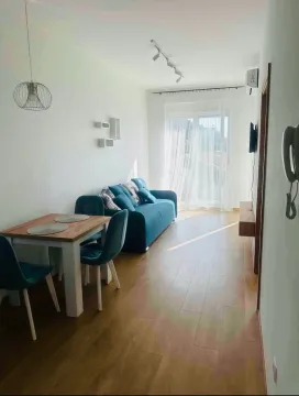 Living room with dining area and sofa. - image 2