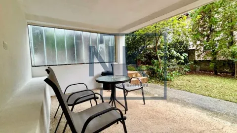 Covered terrace with a table and chairs and a view of the yard. - image 11