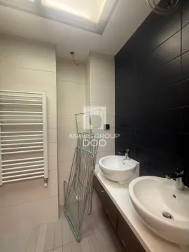 Bathroom with two washbasins and a white towel radiator. - image 15