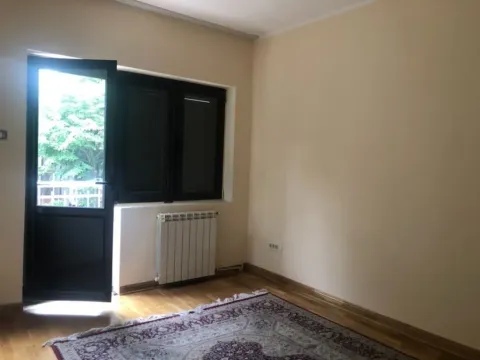 An empty room with parquet flooring, a radiator, and a balcony door. - image 8