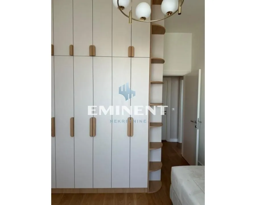 Bedroom with a built-in wardrobe and wooden flooring.
