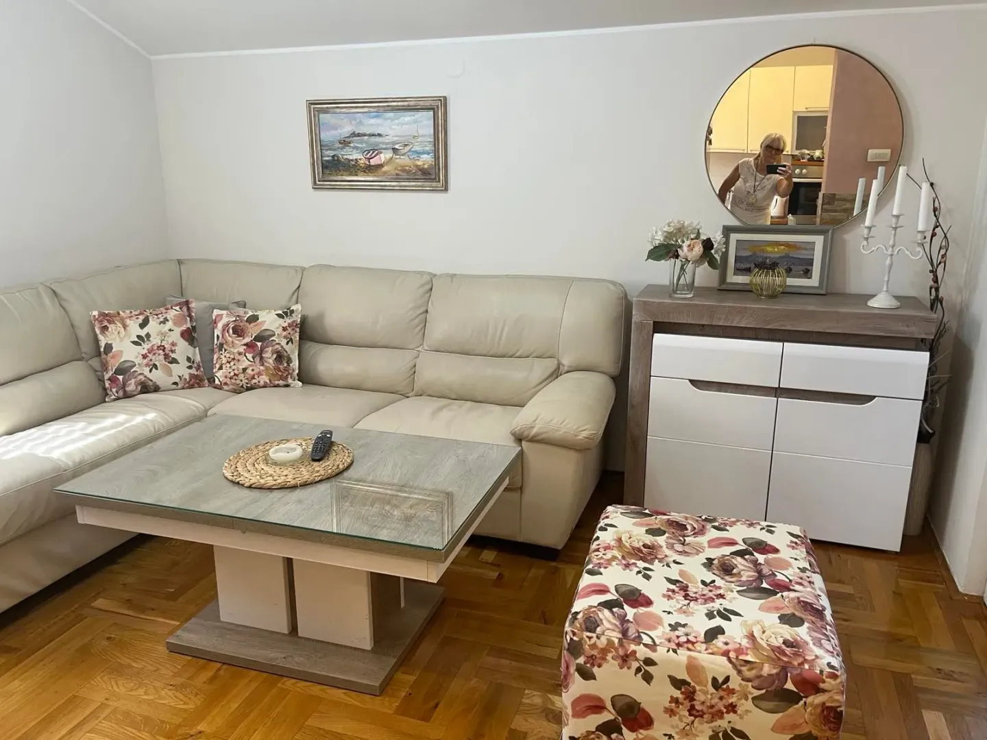 Living room with a sectional sofa, coffee table and chest of drawers.