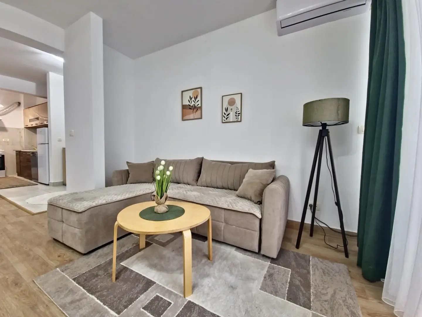 Living room with a corner sofa, coffee table, and floor lamp.