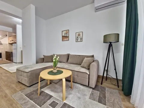 Living room with a corner sofa, coffee table, and floor lamp. - image 11