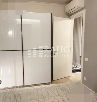 Modern bedroom with a large wardrobe and a double bed. - image 10