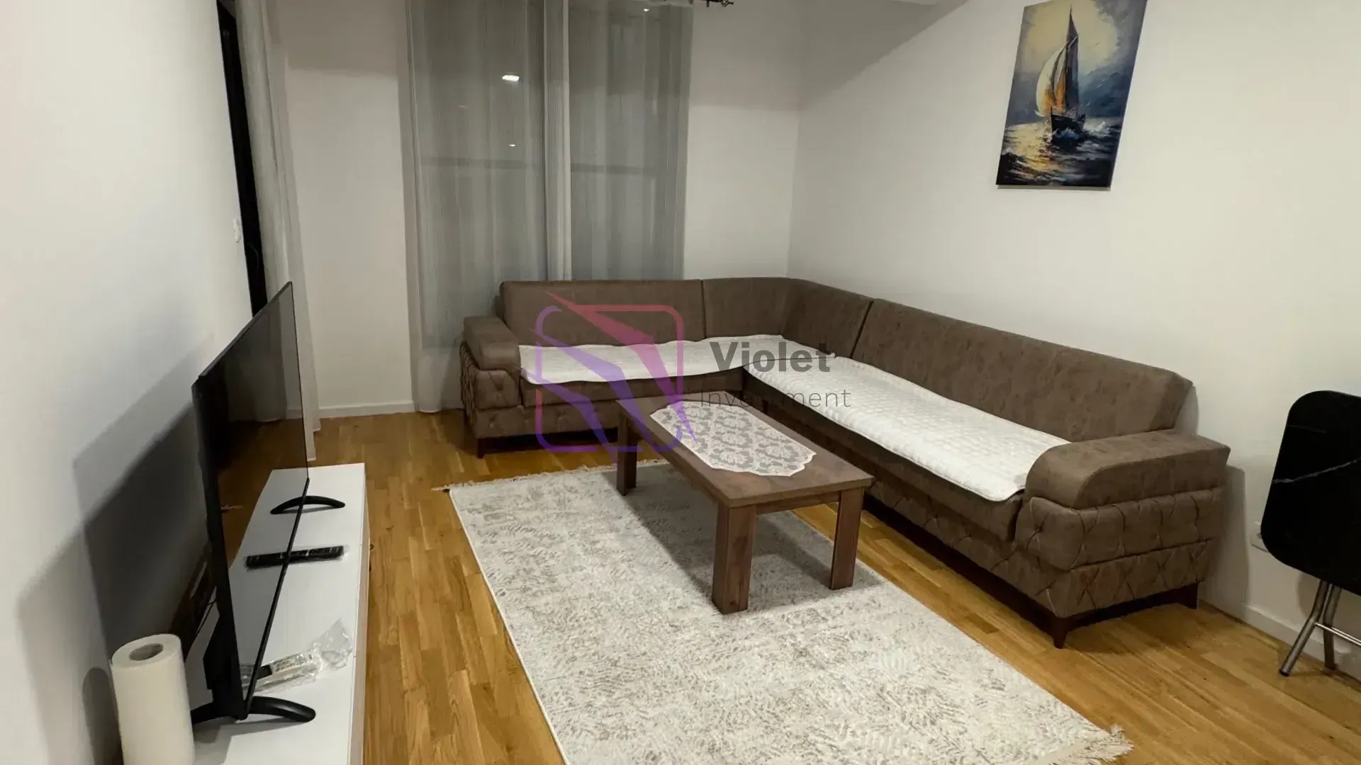 Living room with a sectional sofa, coffee table, and TV.