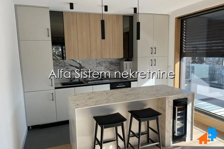 Modern kitchen with an island, built-in units, and bar stools.