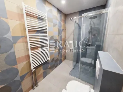 Modern bathroom with a shower cabin and radiator. - image 10
