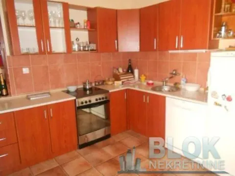 Kitchen with wooden cabinets, stove, and sink. - image 5