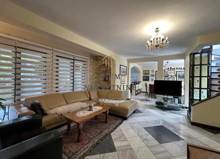 Spacious living room with a sofa set and marble floor.