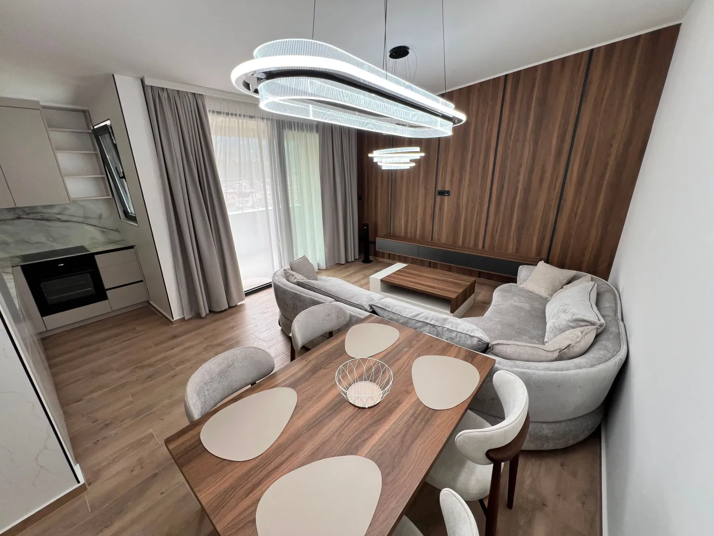 Modern living room with dining area and open-plan kitchen.