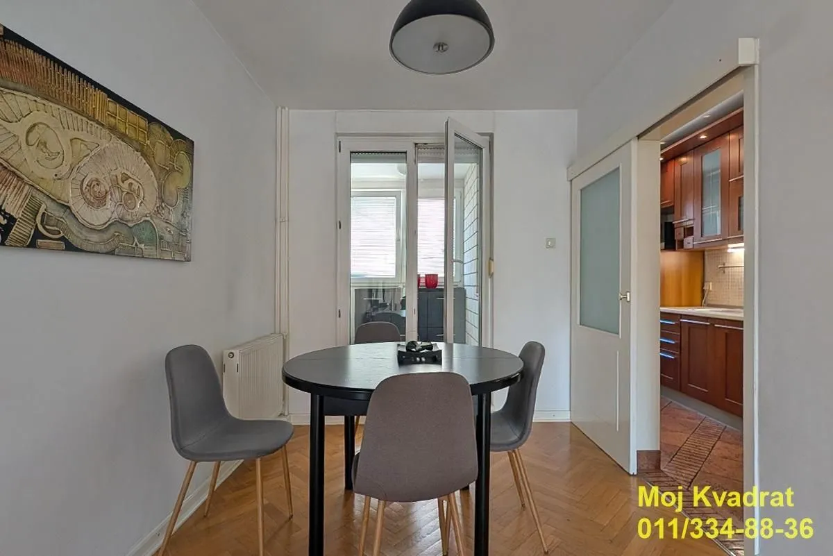 Dining area with a round table and chairs, overlooking the terrace.