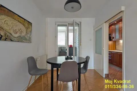 Dining area with a round table and chairs, overlooking the terrace. - image 2