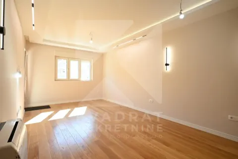 Empty room with hardwood flooring and modern lighting. - image 14