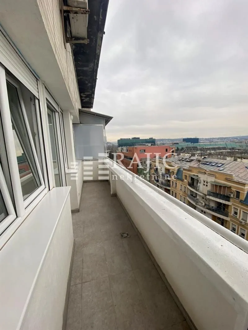 Long balcony with a city view.
