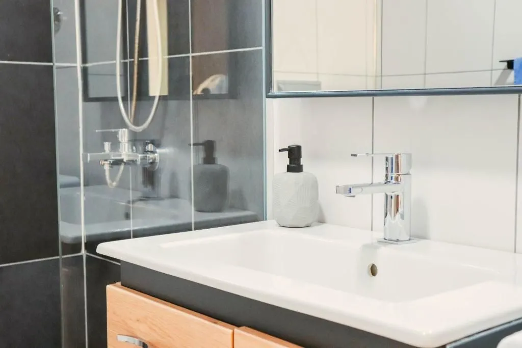 Close-up view of a washbasin and faucet in a modern bathroom.