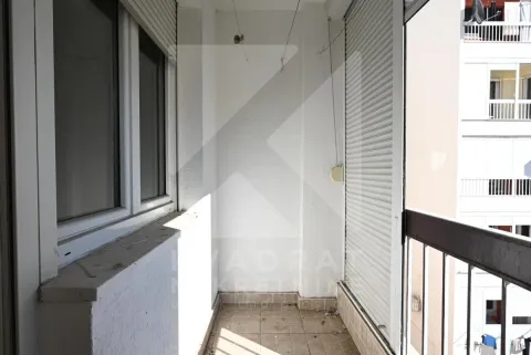 Smaller enclosed balcony with tiled flooring and a view of surrounding buildings. - image 24