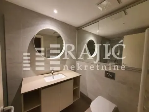 Modernly equipped bathroom with a washbasin and mirror. - image 12
