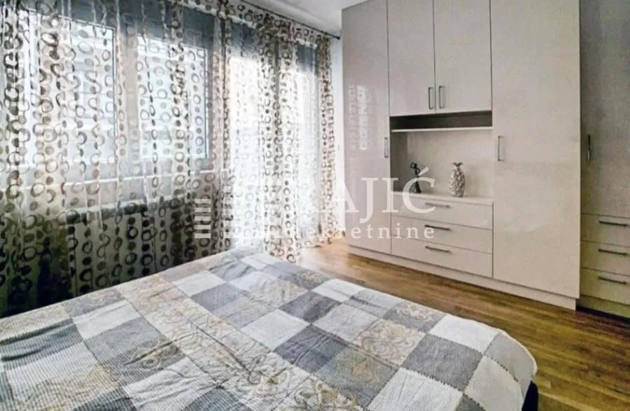 Furnished bedroom with a large wardrobe and a double bed.