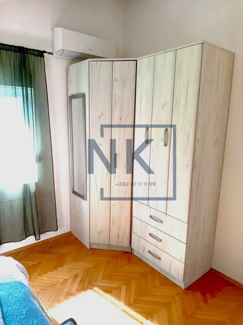 Bedroom with a large wardrobe and wooden flooring.