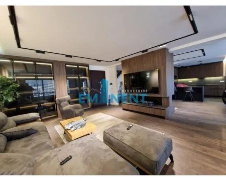 Spacious living room connected to the kitchen, equipped with modern furniture and recessed lighting. - image 3