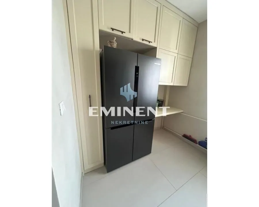 Kitchen with built-in units and a large refrigerator.