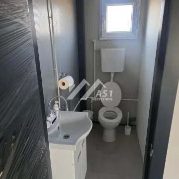 Small bathroom with a sink and a toilet. - image 7
