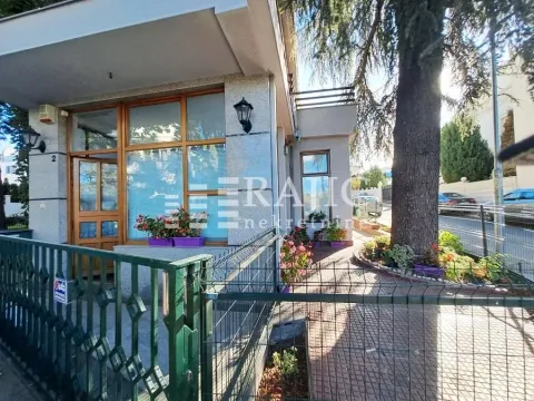 Exterior of the commercial building with entrance and fence. - image 3