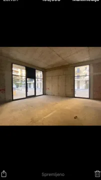 Unfinished commercial space in grey phase with large glass surfaces. - image 5