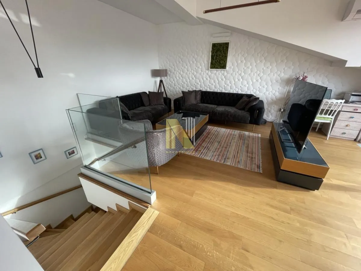 Spacious living room with a sofa set and a staircase in the attic.