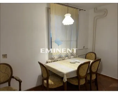Dining area with a table, chairs, and a window. - image 2