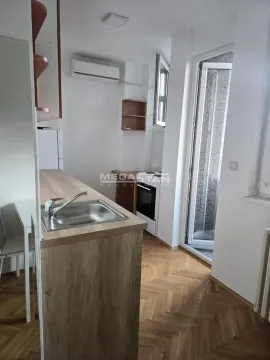 Small kitchen with a sink on the counter and access to the terrace. - image 4
