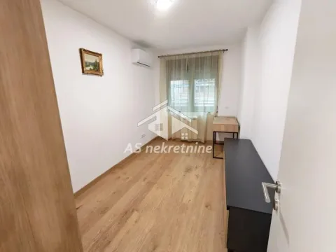 Smaller room with parquet flooring, a window, and furniture. - image 16