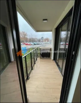 Covered balcony with ceramic tiled floor and glass railing. - image 19