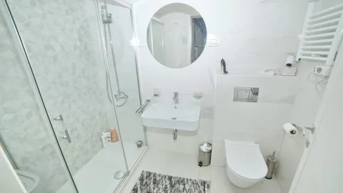Modernly equipped bathroom with a shower cabin and white sanitary ware. - image 10