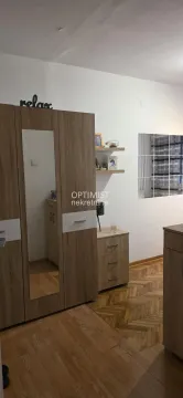 Bedroom with wooden wardrobe, chest of drawers, and parquet flooring. - image 11