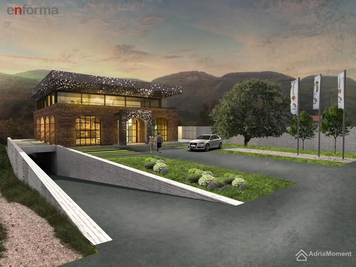 Exterior view of a modern building with a landscaped yard and garage driveway.
