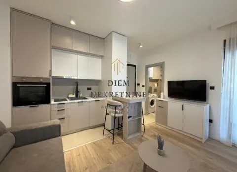 Living room with kitchen and dining area in bright tones. - image 7