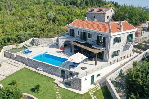 Aerial view of a stone house with a swimming pool and landscaped yard. - image 5