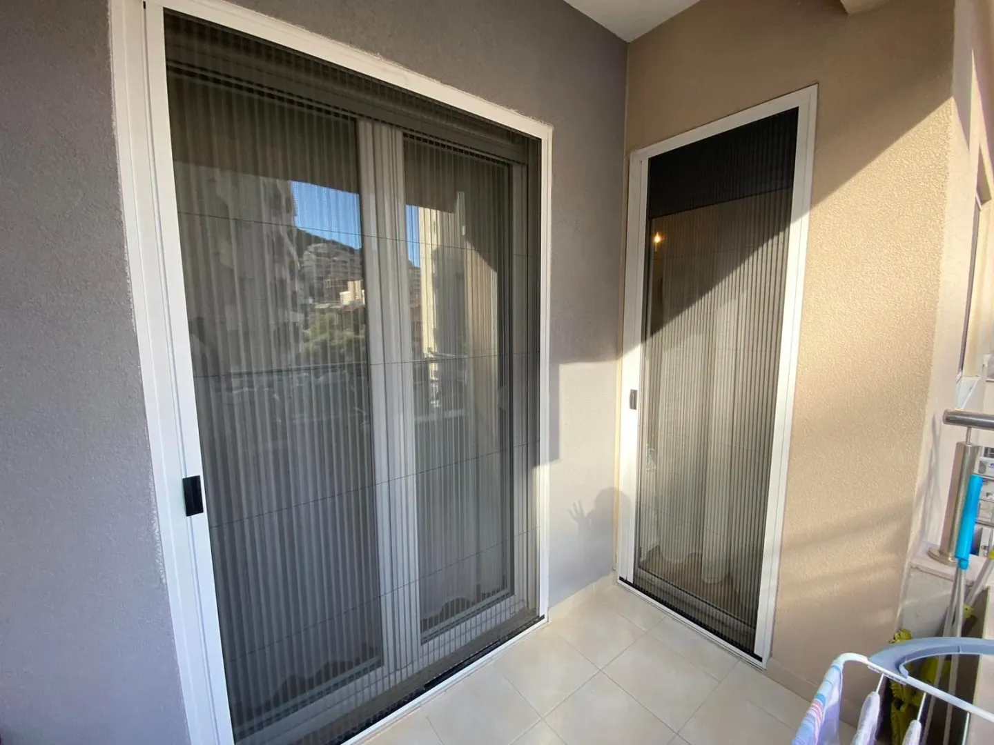 Balcony with built-in insect screens on the doors.