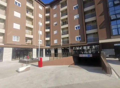 Exterior of a modern residential building with a garage entrance. - image 5