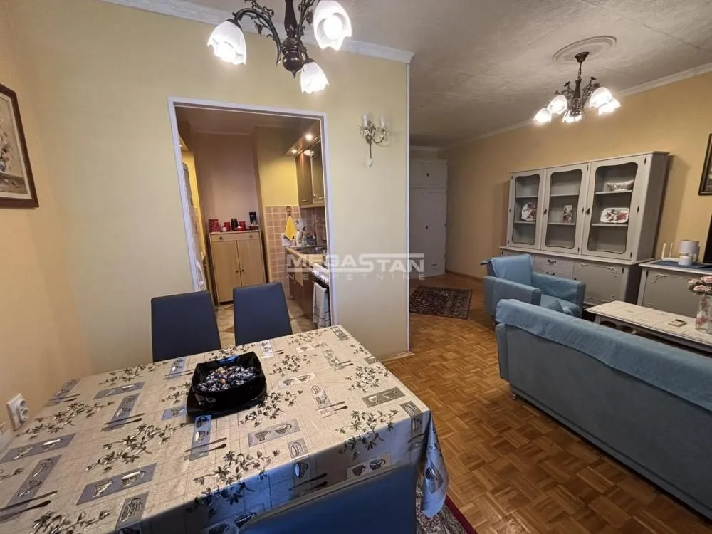 Living room with dining area and view of the kitchen.