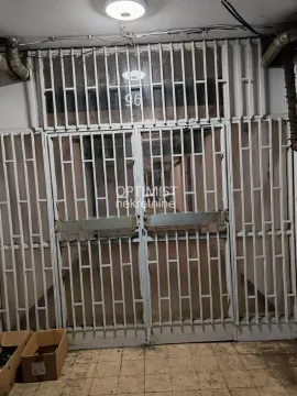 Entrance door with protective grilles and cardboard boxes on the floor. - image 6