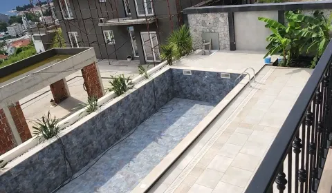 View from the terrace of the courtyard with a swimming pool and surrounding buildings under construction. - image 7