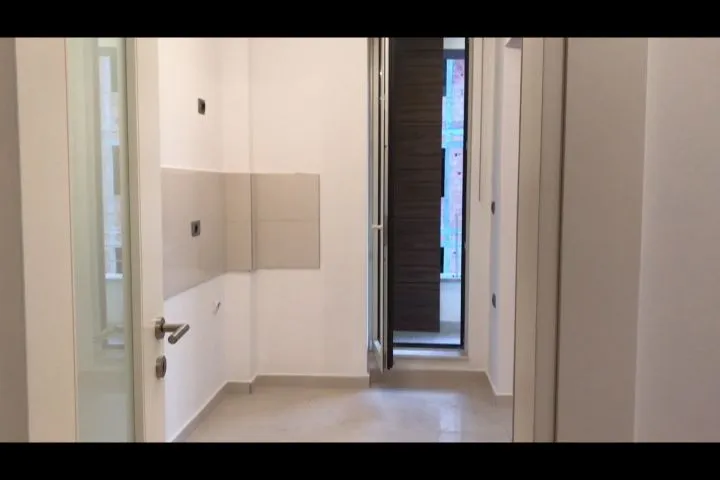 Svijetao prazan prostor u novom stanu sa otvorenim vratima.