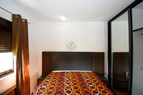 Bedroom with a double bed, headboard, and a large built-in wardrobe with a mirror. - image 15