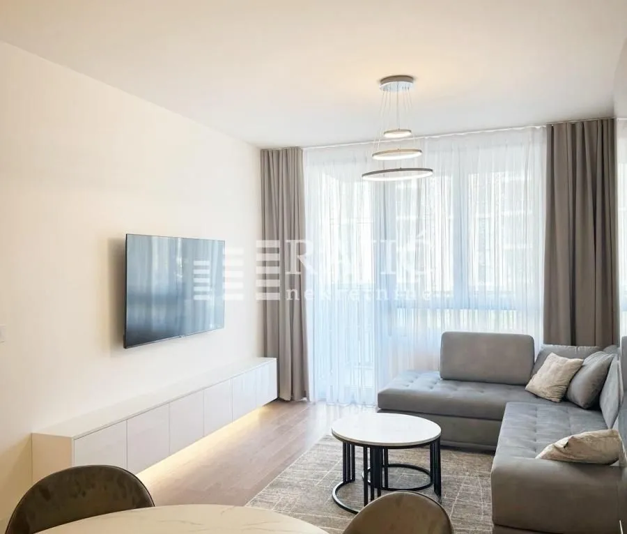 Living room with a sofa, TV, and dining table.