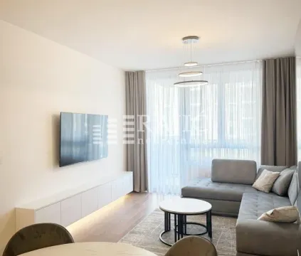 Living room with a sofa, TV, and dining table. - image 3