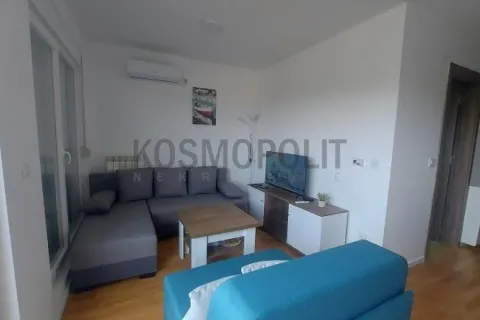 Living room with a sectional sofa, TV, and air conditioning unit. - image 3