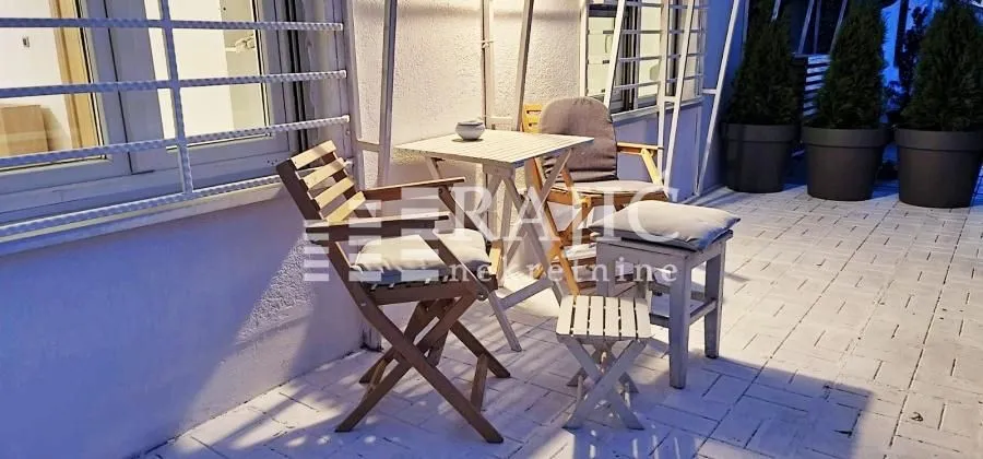 Furnished terrace with seating set.